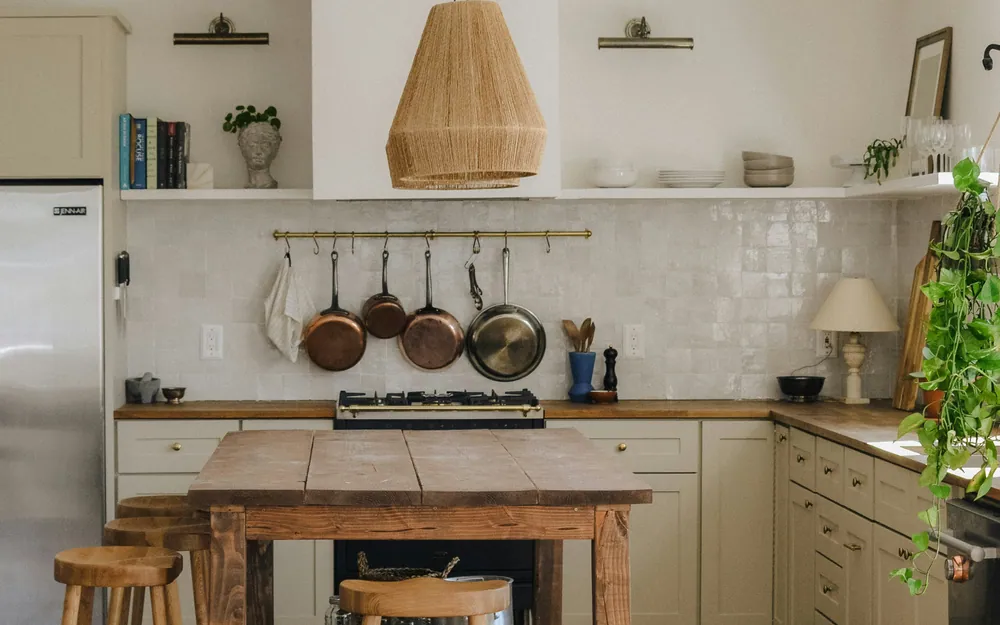 Renovated kitchen with a large island, custom cabinetry, and warm pendant lighting